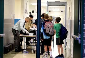 Students at Waccamaw Middle School pass through metal detectors as they arrive at school in Pawleys Island.