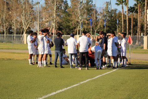 The boys Varsity Soccer Team huddles during halftime against La Sierra Academy 