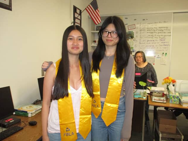 Natalie Luu and Cindy Nguyen get their FBLA stoles.
